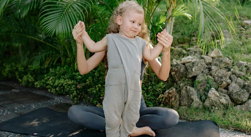 A baby doing yoga with their mum