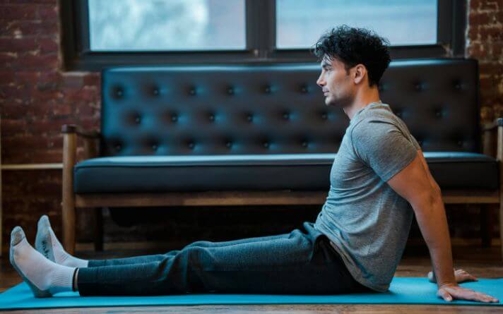 Man sitting upright after doing exercise.