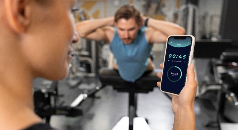 Someone using fitness app at the gym